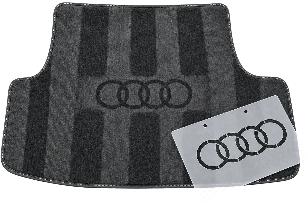 Audi stencil beside its finished logo effect on a detailed car mat