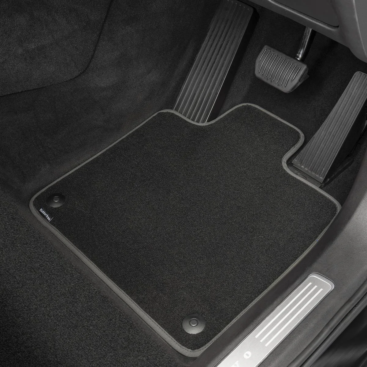 Custom physical car logo stencil preview positioned on an automotive carpet mat